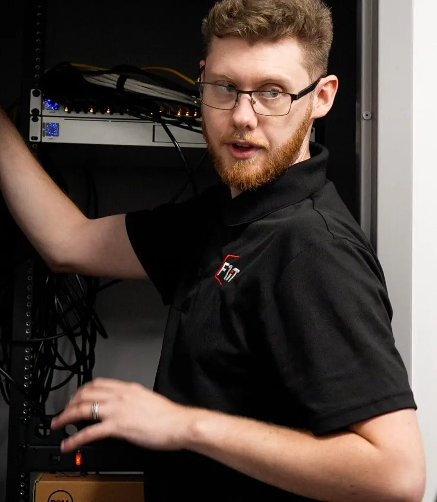 Person working on server equipment.