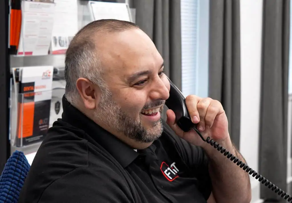 Person on phone in office setting.